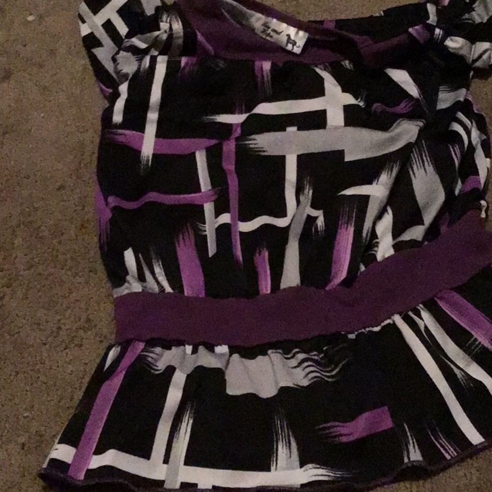 A black hire and purple shirt